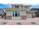 Beautiful stucco home featuring stone accents, manicured landscaping, and a two-car garage at 8426 W Solano Dr, Glendale, AZ 85305
