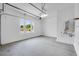 Spacious and well-lit garage with epoxy flooring and a tankless water heater at 8426 W Solano Dr, Glendale, AZ 85305