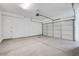 Clean, spacious garage with a roll-up door and plenty of room for parking and storage at 8426 W Solano Dr, Glendale, AZ 85305