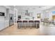 Modern kitchen featuring stainless steel appliances, a large island with seating, and wood flooring at 8426 W Solano Dr, Glendale, AZ 85305