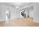 Elegant living room features wood floors, a decorative chandelier, and an open floor plan at 8426 W Solano Dr, Glendale, AZ 85305