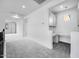 Well-lit loft with built-in desk space, modern cabinetry, and neutral carpeting at 8426 W Solano Dr, Glendale, AZ 85305