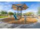 Community playground featuring a modern play structure with slide, climbing ropes, and shade canopy for children at 8426 W Solano Dr, Glendale, AZ 85305