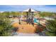Community playground featuring a modern play structure with slide, climbing ropes, and shade canopy at 8426 W Solano Dr, Glendale, AZ 85305