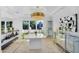 Bright dining area with modern chandelier and mirrored bar area at 8935 N 82Nd St, Scottsdale, AZ 85258