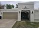 Charming single-story home features an attached garage, decorative gate, and well-maintained lawn at 8935 N 82Nd St, Scottsdale, AZ 85258