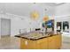 Kitchen island featuring an eat in countertop with a view of the backyard through sliding doors at 8935 N 82Nd St, Scottsdale, AZ 85258