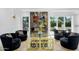 Cozy living room featuring armchairs, a modern fireplace, and backyard access at 8935 N 82Nd St, Scottsdale, AZ 85258