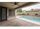 Relaxing back patio with refreshing pool, water feature, and desert landscaping at 9041 W Redbird Rd, Peoria, AZ 85383