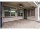A cozy covered back patio is perfect for relaxing outdoors with brick pavers and ceiling fan at 9041 W Redbird Rd, Peoria, AZ 85383