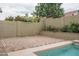 Beautiful backyard featuring brick pavers and a mature landscape with colorful flowers behind the privacy wall at 9041 W Redbird Rd, Peoria, AZ 85383