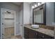 Elegant bathroom with granite counters, vessel sink, dark cabinets, and modern lighting at 9041 W Redbird Rd, Peoria, AZ 85383