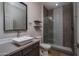 Bathroom featuring a sleek vessel sink, tiled shower, and modern fixtures at 9041 W Redbird Rd, Peoria, AZ 85383
