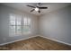 Bedroom with plantation shutters and wood laminate flooring at 9041 W Redbird Rd, Peoria, AZ 85383