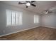 Bedroom with plantation shutters and wood laminate flooring at 9041 W Redbird Rd, Peoria, AZ 85383