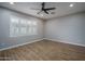 Bedroom features wood-style flooring, recessed lighting and large window at 9041 W Redbird Rd, Peoria, AZ 85383
