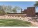 Inviting community entrance with desert landscaping, creating a welcoming and attractive first impression at 9041 W Redbird Rd, Peoria, AZ 85383