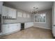 Bright dining area with shuttered windows and a modern light fixture at 9041 W Redbird Rd, Peoria, AZ 85383