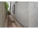 Exterior view of side yard with trash cans and narrow brick pathway at 9041 W Redbird Rd, Peoria, AZ 85383