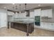 Spacious kitchen with stainless steel appliances, large island, and abundant storage in white cabinetry at 9041 W Redbird Rd, Peoria, AZ 85383