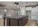Kitchen featuring a large island with seating, stainless steel appliances, and white cabinetry at 9041 W Redbird Rd, Peoria, AZ 85383