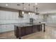 Spacious kitchen features an oversized island, stainless steel appliances, and white cabinetry at 9041 W Redbird Rd, Peoria, AZ 85383