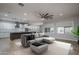 The open-concept living room flows seamlessly into the kitchen, featuring tile flooring and natural lighting at 9041 W Redbird Rd, Peoria, AZ 85383