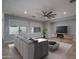 Bright living room with tile flooring, large windows, modern ceiling fan, and neutral decor at 9041 W Redbird Rd, Peoria, AZ 85383