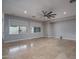 Spacious living room with neutral walls, tile floors, and ample natural light from large windows at 9041 W Redbird Rd, Peoria, AZ 85383