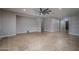 Open-concept living room showcasing tile floors, neutral walls, and recessed lighting at 9041 W Redbird Rd, Peoria, AZ 85383