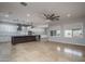 The open-concept living room boasts tile flooring and large windows offering plenty of natural lighting at 9041 W Redbird Rd, Peoria, AZ 85383