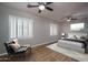 This main bedroom features stylish ceiling fans, plantation shutters, and wood laminate flooring at 9041 W Redbird Rd, Peoria, AZ 85383