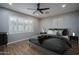 Comfortable main bedroom with wood floors, and a modern ceiling fan for a relaxed setting at 9041 W Redbird Rd, Peoria, AZ 85383