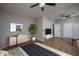 Spacious main bedroom featuring a ceiling fan, wood laminate flooring, and stylish decor at 9041 W Redbird Rd, Peoria, AZ 85383