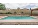 Inviting pool area with a water feature and comfortable lounging area surrounded by lush landscaping at 9041 W Redbird Rd, Peoria, AZ 85383
