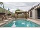 Relaxing backyard featuring a pool, gazebo, and waterfall creating a private retreat at 9041 W Redbird Rd, Peoria, AZ 85383