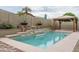 Backyard swimming pool boasts a tranquil waterfall and desert landscaping feature at 9041 W Redbird Rd, Peoria, AZ 85383