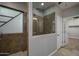 Luxurious shower features glass doors, stone surround, and multiple shower heads at 9041 W Redbird Rd, Peoria, AZ 85383