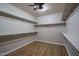 Spacious walk-in closet features ample shelving and wood-look flooring at 9041 W Redbird Rd, Peoria, AZ 85383
