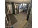Spacious kitchen with stainless steel refrigerator, white cabinets and an archway at 9501 E Broadway Rd # 21, Mesa, AZ 85208