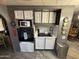 Compact kitchen with a microwave and smooth cooktop, complete with upper and lower cabinets at 9501 E Broadway Rd # 21, Mesa, AZ 85208