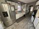 Well-lit kitchen features a stainless steel refrigerator and white cabinets at 9501 E Broadway Rd # 21, Mesa, AZ 85208