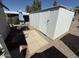 Backyard storage shed, small patio, table with umbrella and landscaped area at 9501 E Broadway Rd # 21, Mesa, AZ 85208