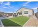 Beautiful backyard with artificial grass, patio, fire pit, dining table, and privacy wall at 10004 S Smythe Dr, Apache Junction, AZ 85120