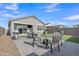 Backyard with artificial grass, outdoor seating, barbecue grill, and a patio, designed for relaxation and entertainment at 10004 S Smythe Dr, Apache Junction, AZ 85120