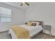 Minimalist bedroom featuring a bed with modern gray headboard, neutral bedding, and a matching nightstand at 10004 S Smythe Dr, Apache Junction, AZ 85120
