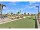 A landscaped bocce ball court features ample seating, trees, and sidewalks in this lovely community at 10004 S Smythe Dr, Apache Junction, AZ 85120