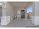 Inviting covered front porch featuring a modern chair and stylish black front door at 10004 S Smythe Dr, Apache Junction, AZ 85120