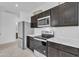 Modern kitchen featuring stainless steel appliances and stone countertops at 10004 S Smythe Dr, Apache Junction, AZ 85120