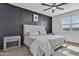 Stylish main bedroom with a dark accent wall, ceiling fan, and soft carpet at 10004 S Smythe Dr, Apache Junction, AZ 85120